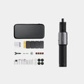 Black hand held rechargeable grinder with USB cable and accessory kit on workbench