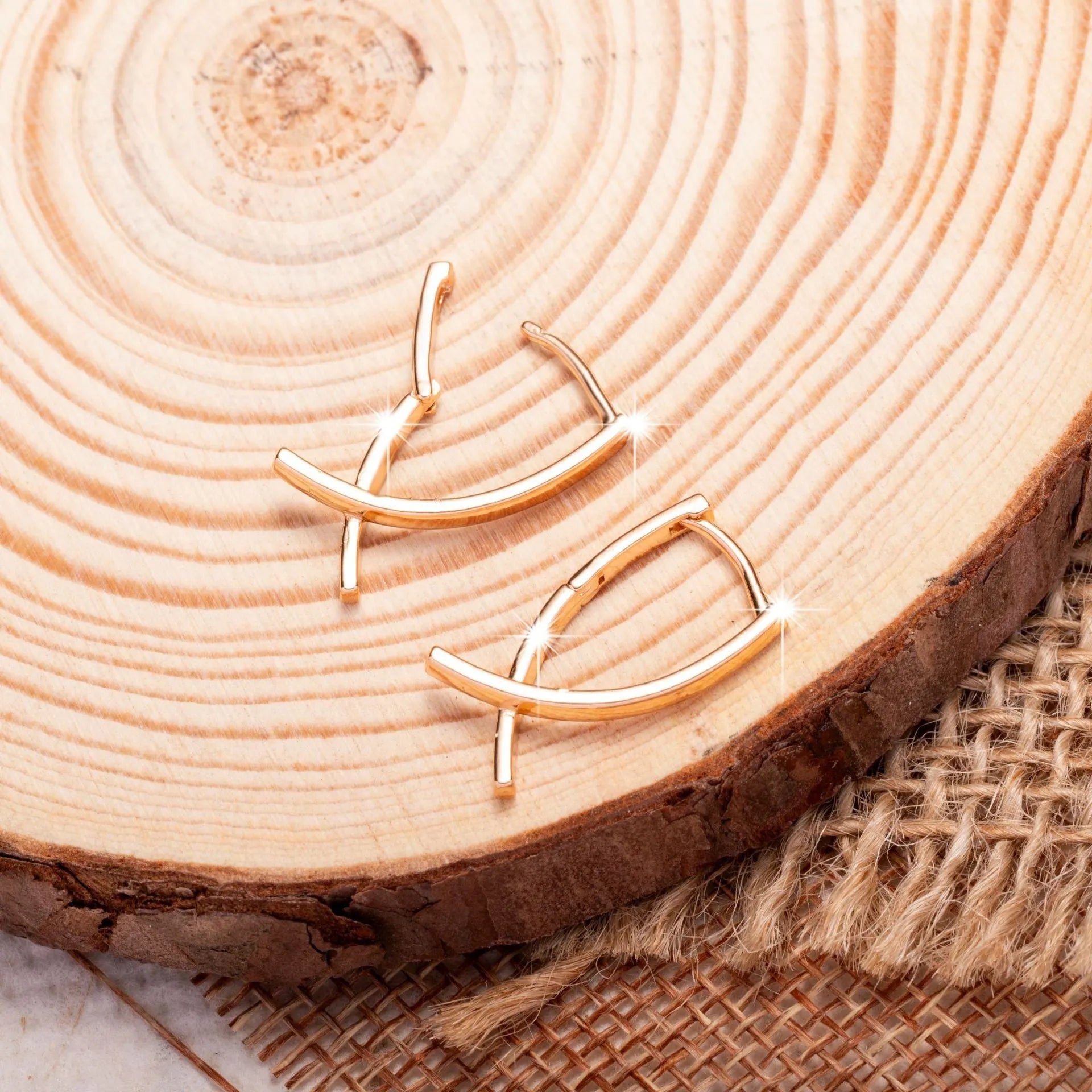 Rose gold plated cross earrings on a white background, showing post and clutch fitting.