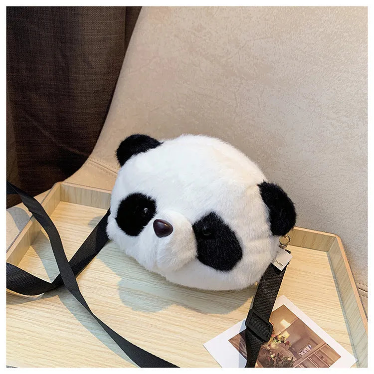 Soft cylindrical plush crossbody bag with panda head design, showing front sandwich pocket.