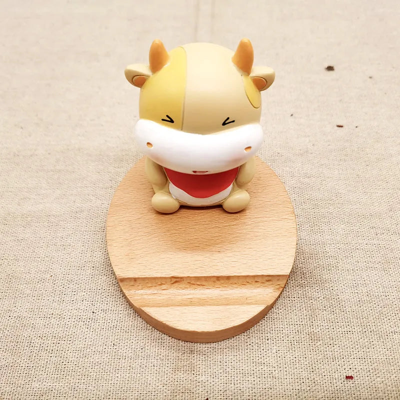 Solid beech wood phone holder with resin puppy decoration and a pound coin in the integrated slot.