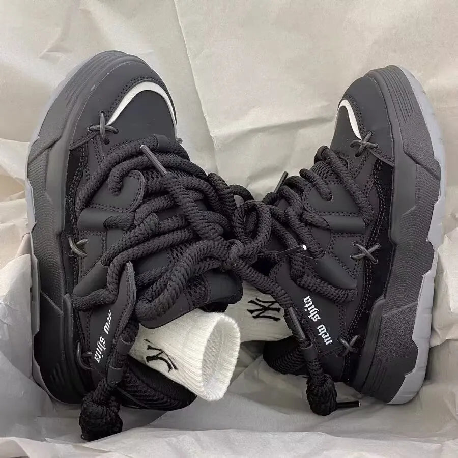 Women's grey retro chunky sneakers with thick sole and front lace-up, shown on a foot