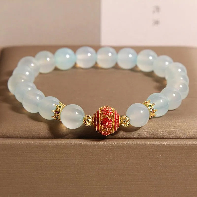 Women's blue agate and crystal bracelet with colourful lucky beads on a wrist.