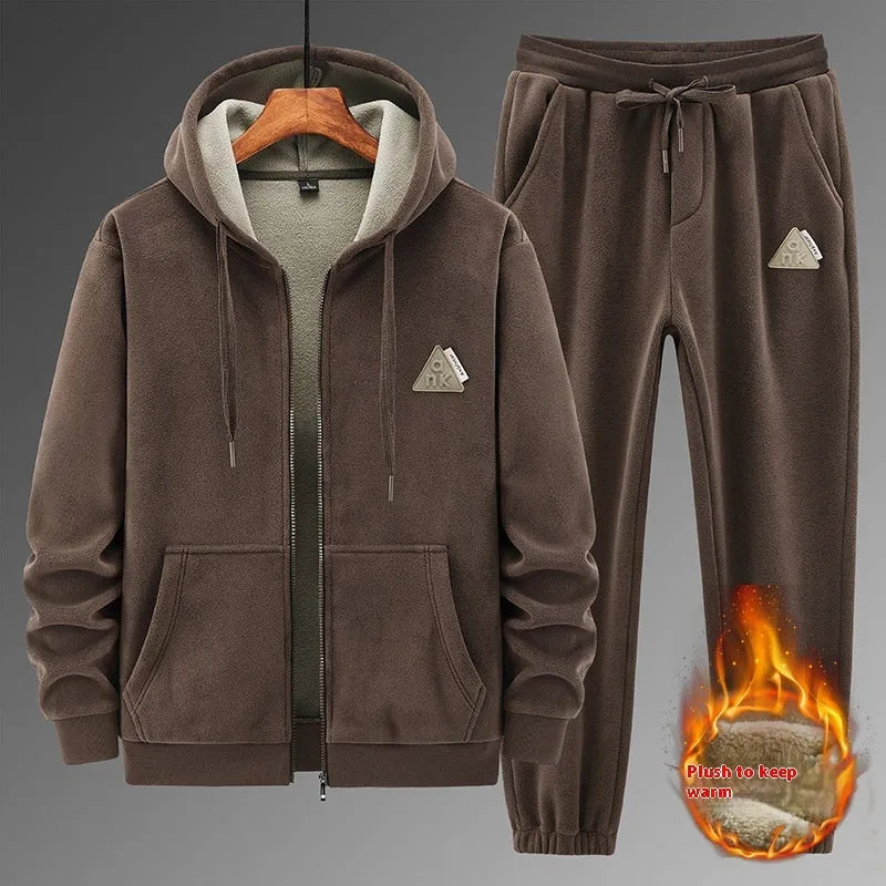 Man wearing a grey hooded sweater and matching casual trousers from a two-piece set.
