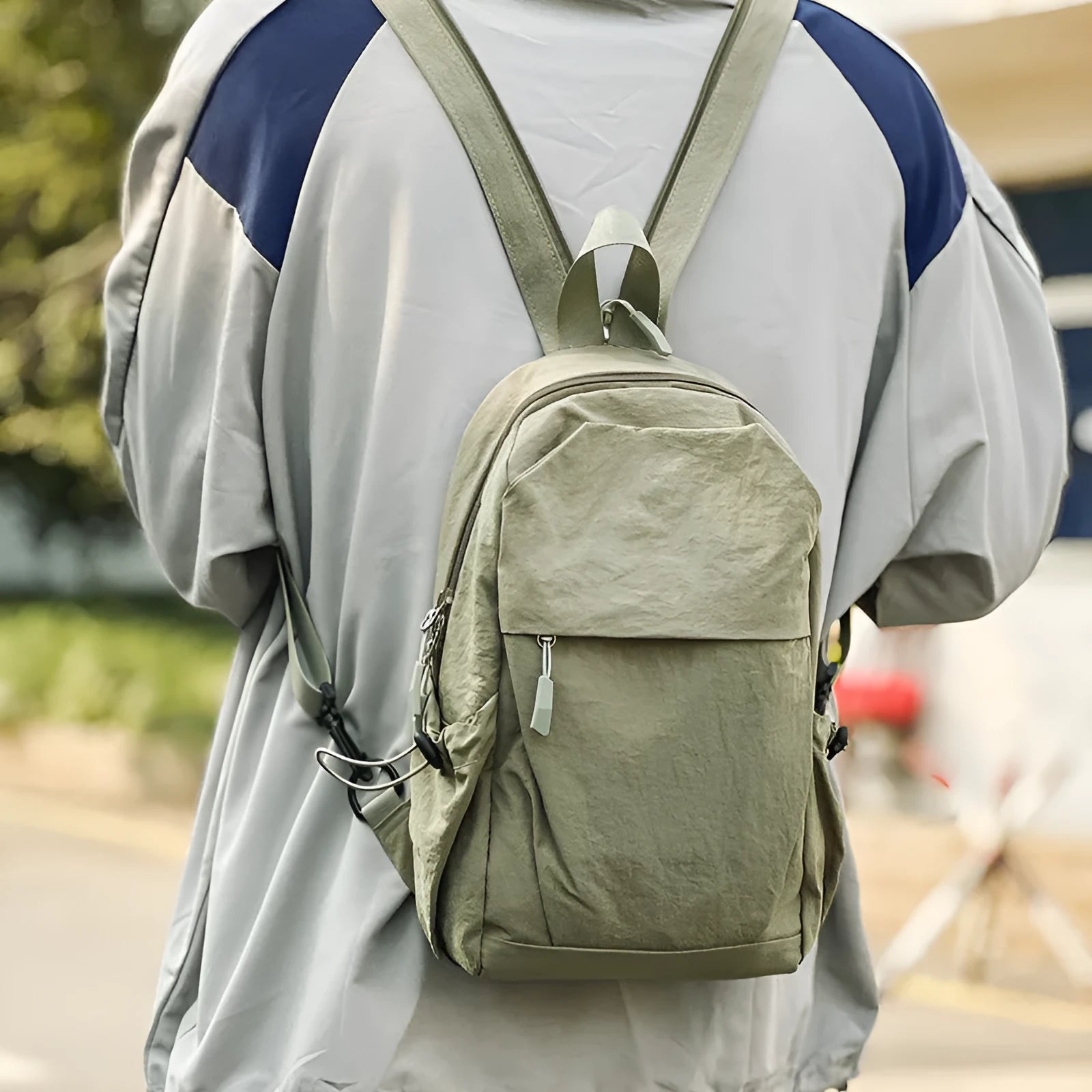 Multi-functional waterproof nylon backpack in black, free size, with curved shoulder strap and visible sewing thread detailing