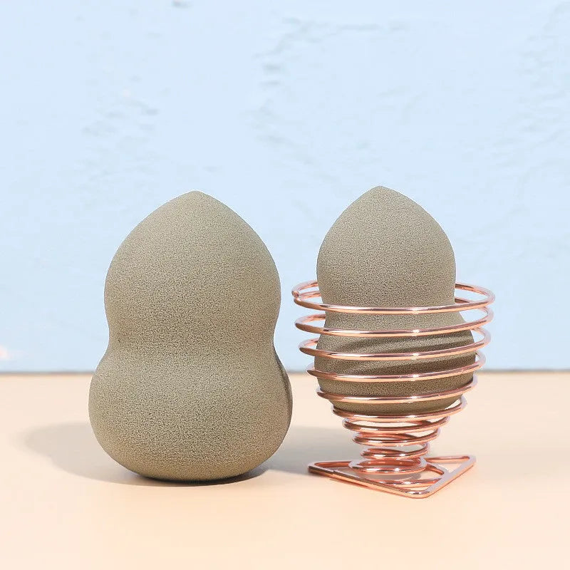 Four coloured hydrophilic polyurethane beauty eggs placed on a metal stand for makeup application