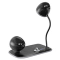 White three-in-one desk lamp with integrated digital clock and wireless charging pad on wooden desktop