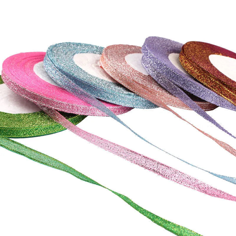 Roll of thin 0.6cm wide polyester ribbon in a selection of 22 colours including metallic gold and sky blue.