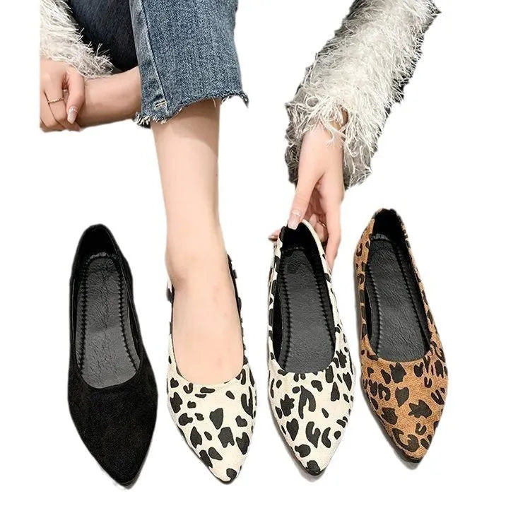 Women's leopard print flat pumps with a pointed toe, low heel, and cotton upper on a rubber sole.