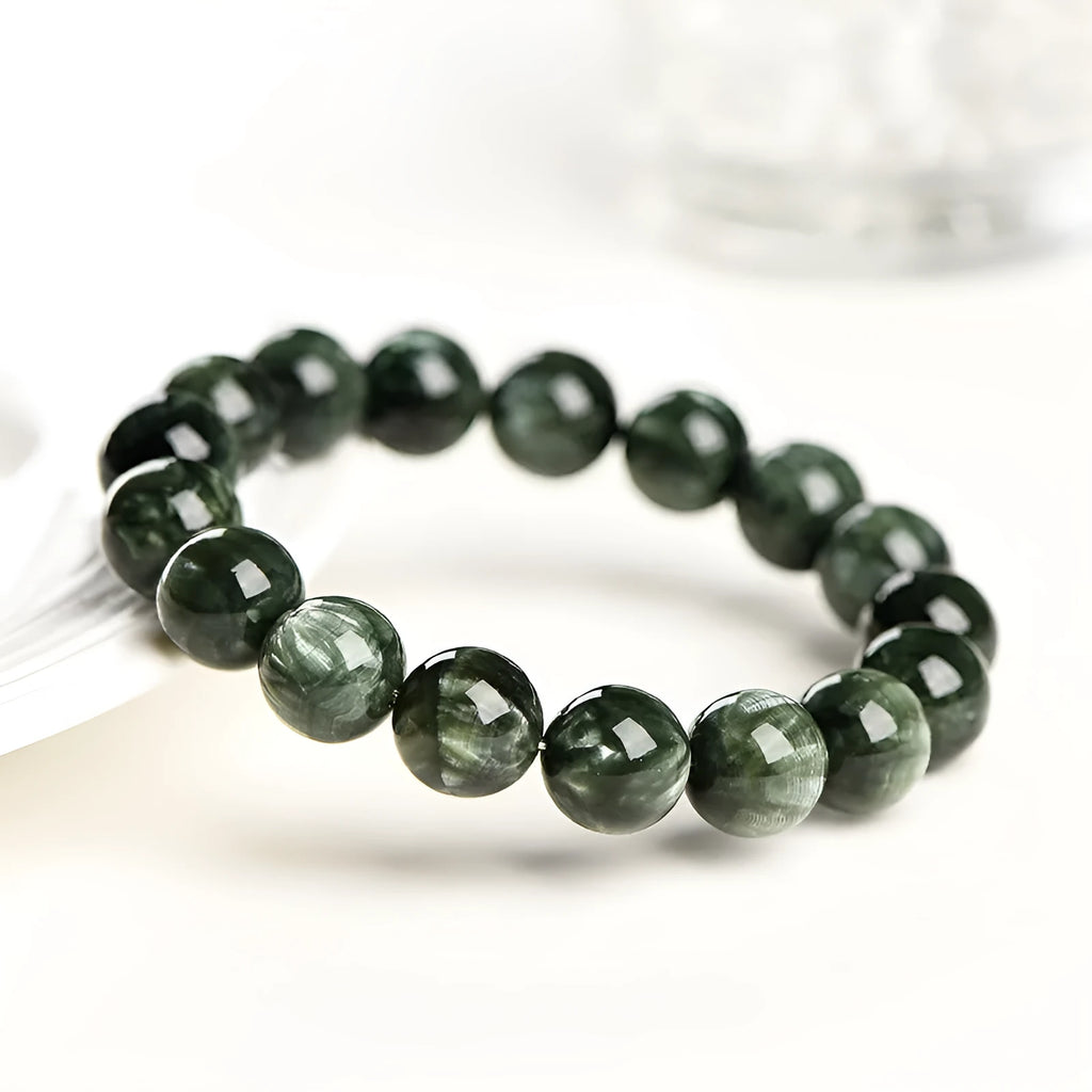 Grade 7A Green Dragon Crystal bracelet with round beads and ruyi design on a wrist.
