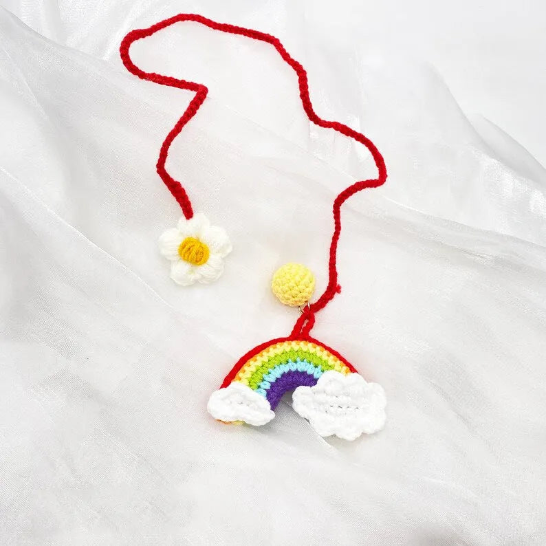 Handmade crocheted wool car pendant in avocado, pink rainbow, or red rainbow colour with cartoon flower design.
