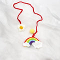 Handmade crocheted wool car pendant in avocado, pink rainbow, or red rainbow colour with cartoon flower design.