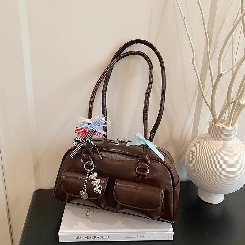 Brown retro pillow-shaped women's handbag with a flap closure and double shoulder straps.