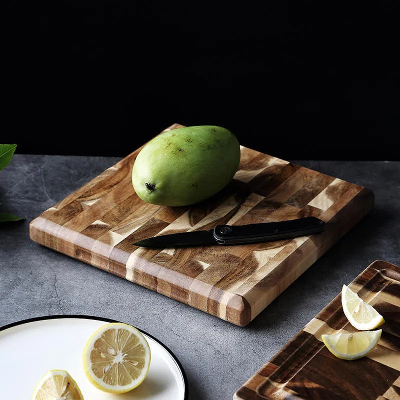 Brown parquet-pattern solid wood chopping board with 3cm thickness on a kitchen counter.