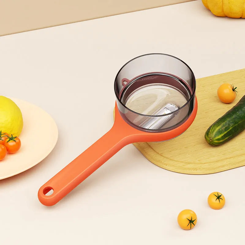 Light green kitchen peeler with integrated bucket storage for catching vegetable and fruit peels
