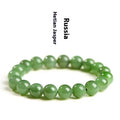 Natural Hetian jade jasper ball bracelet showing polished beads on a wrist.
