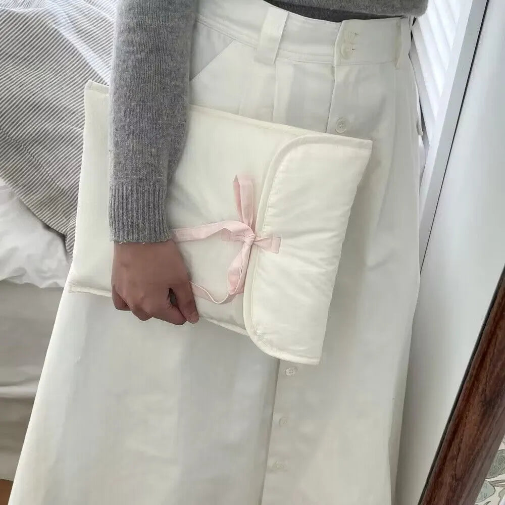 Black and white women's quilted nylon laptop bag with ballet bow in two size options.
