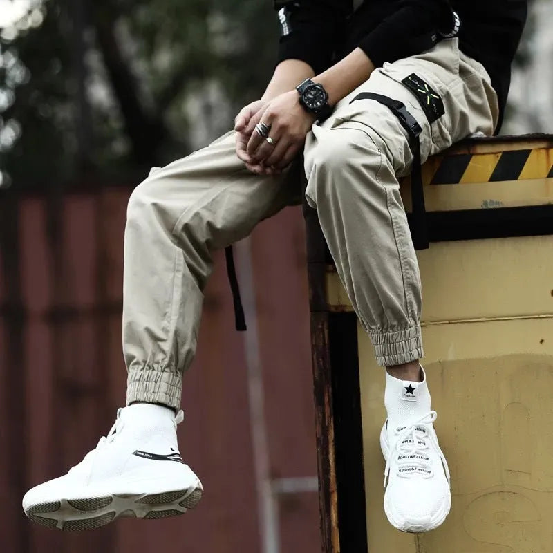 Men's cotton cargo pants in black, grey, and khaki, casual multi-pocket trousers with size chart.