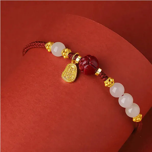 Handmade women's bracelet with cinnabar red rope, 925 silver, and Hetian jade on an adjustable chain.