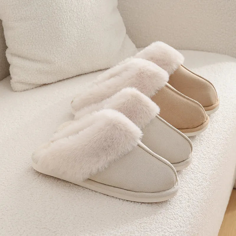 Brown plush indoor slippers for women with a non-slip PVC sole on a wooden floor.