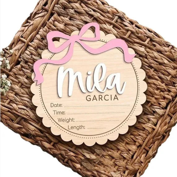 Square wooden baby room ornament with a customised name, shown in two size options.