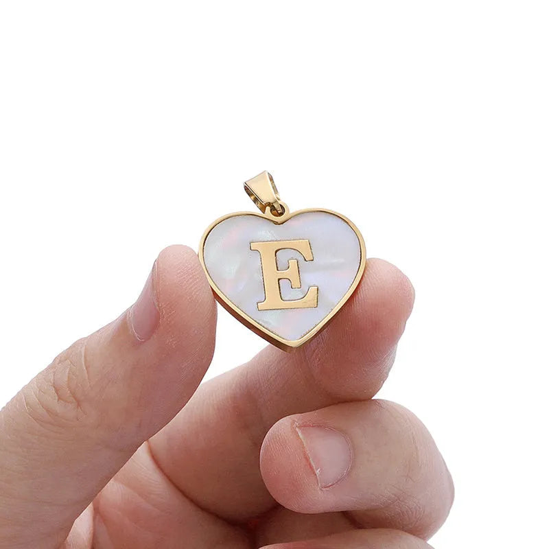 Gold plated heart-shaped white shell necklace with personalised text on a stainless steel chain.