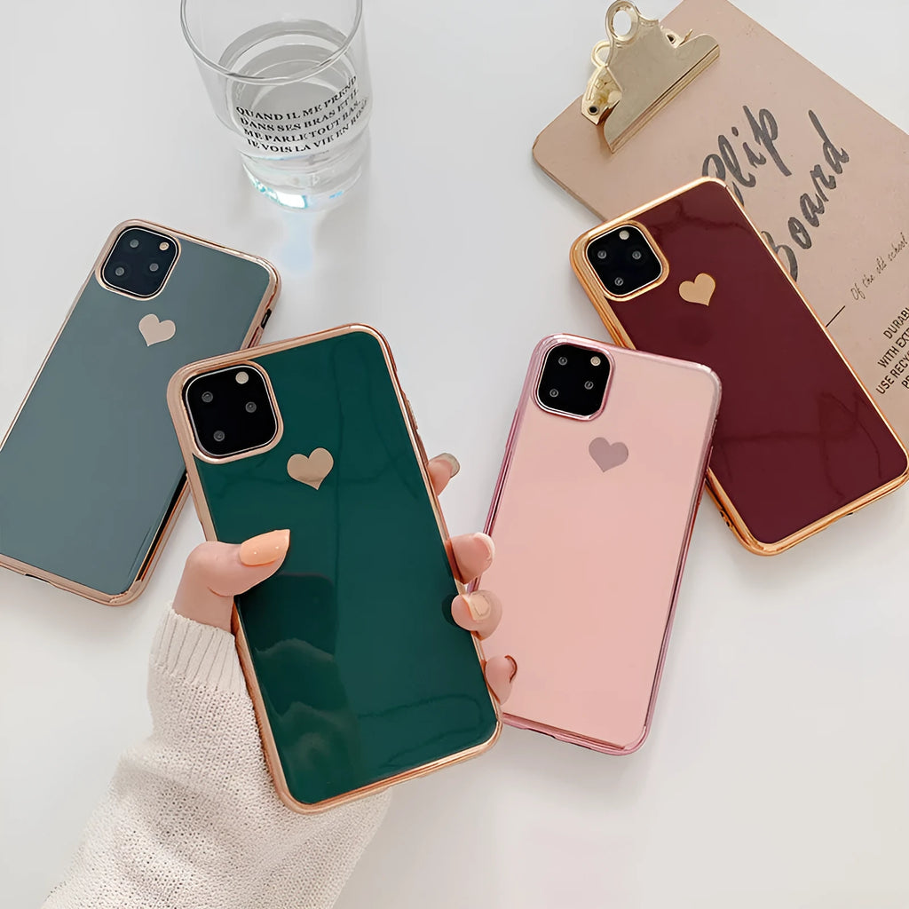 Solid colour TPU back cover case for iPhone on a table, showing blue, claret, pink, and green options.