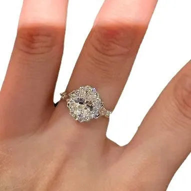 Geometric silver adjustable ring with an elliptical diamond on an index finger.