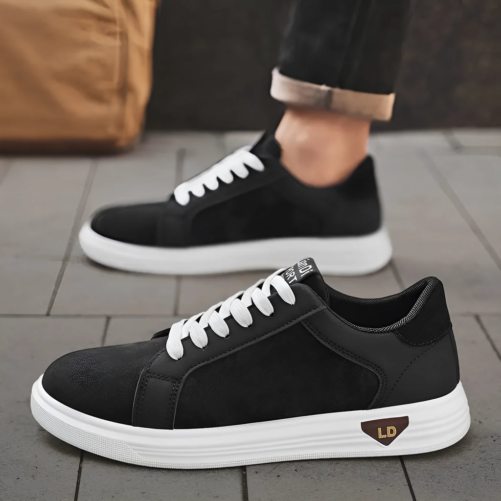 Men's black snake pattern PU leather casual sneakers with round toe and flat rubber sole on a white background