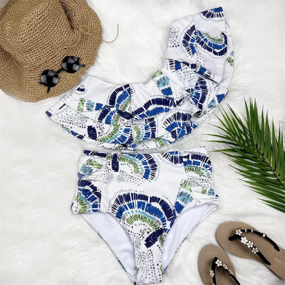 White women's one-shoulder bikini with a large lotus leaf design and split front.
