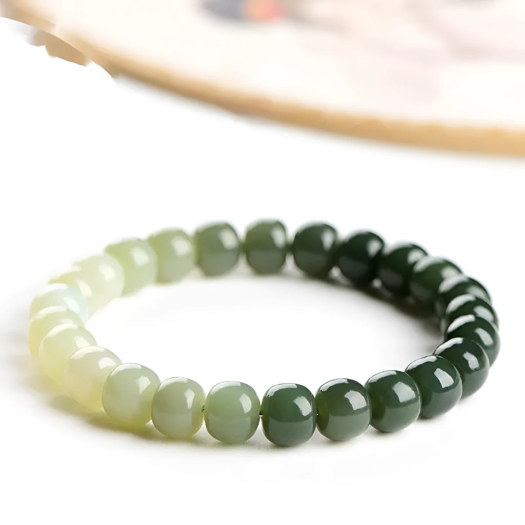 Natural Hetian jade bracelet with gradient clear water colour and polished beads.