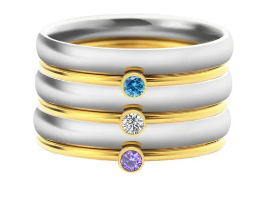 Geometric engraved titanium steel ring with December birthstone colours on a hand.