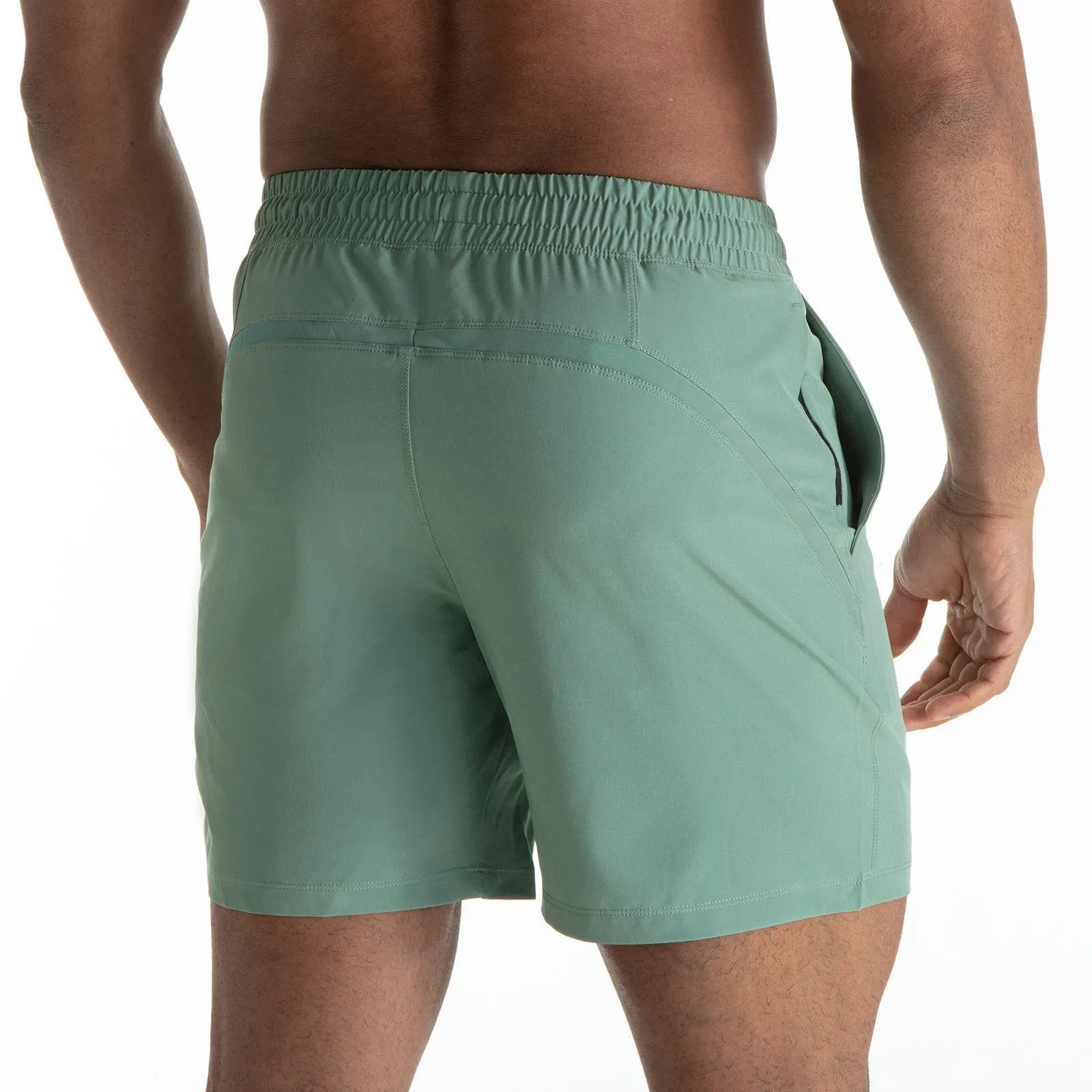 Men's black quick-drying sports shorts with mesh stitching detail on a grey background.