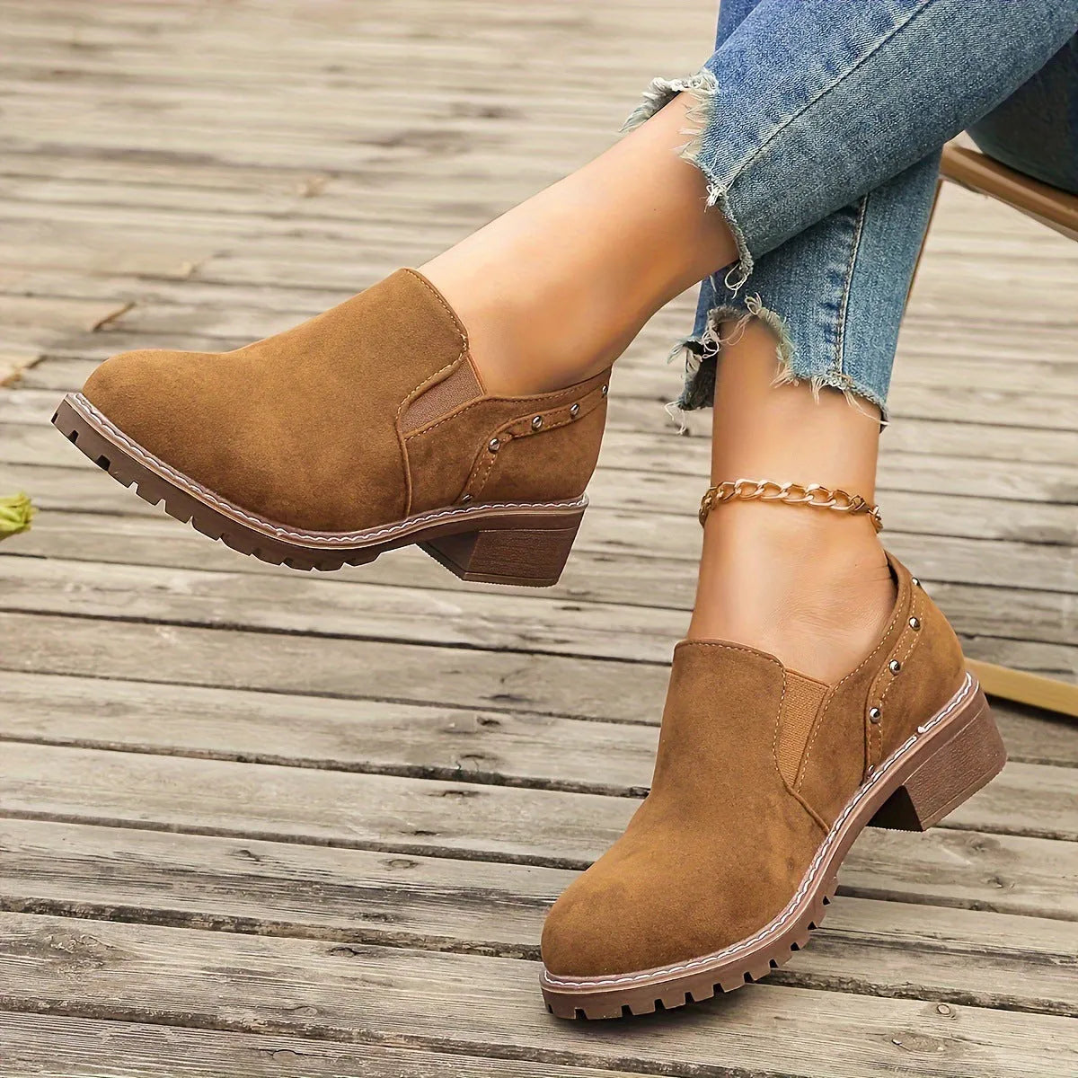 Women's light brown suede ankle boots with a low thick heel and elasticated ankle band.