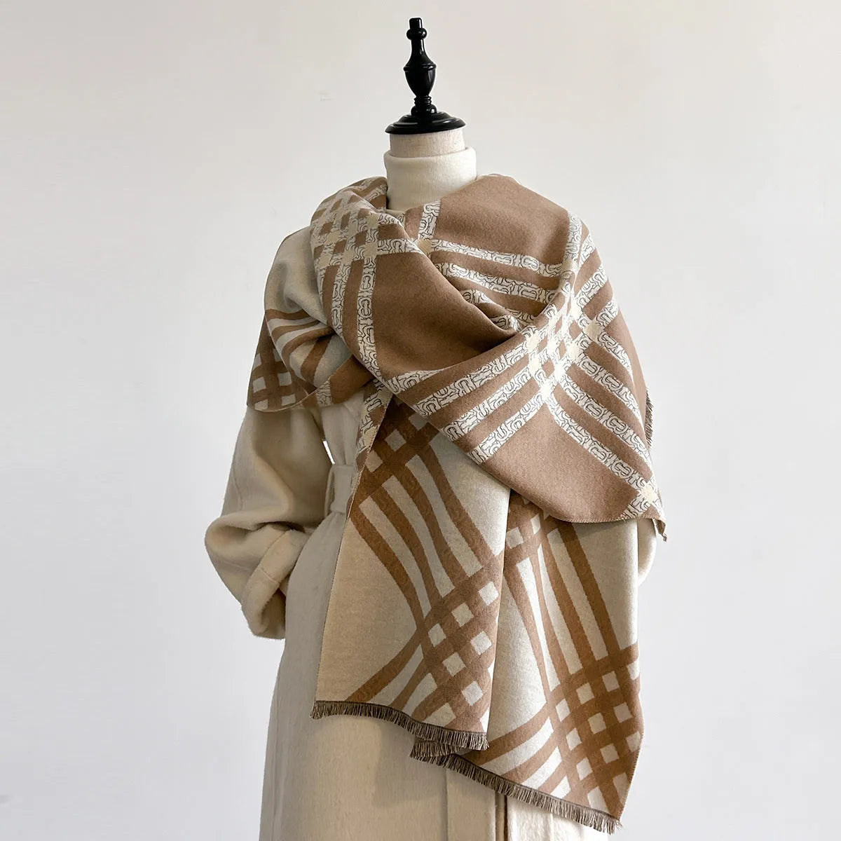 Mid-length brown imitation cashmere winter scarf with tassel trim laid flat.