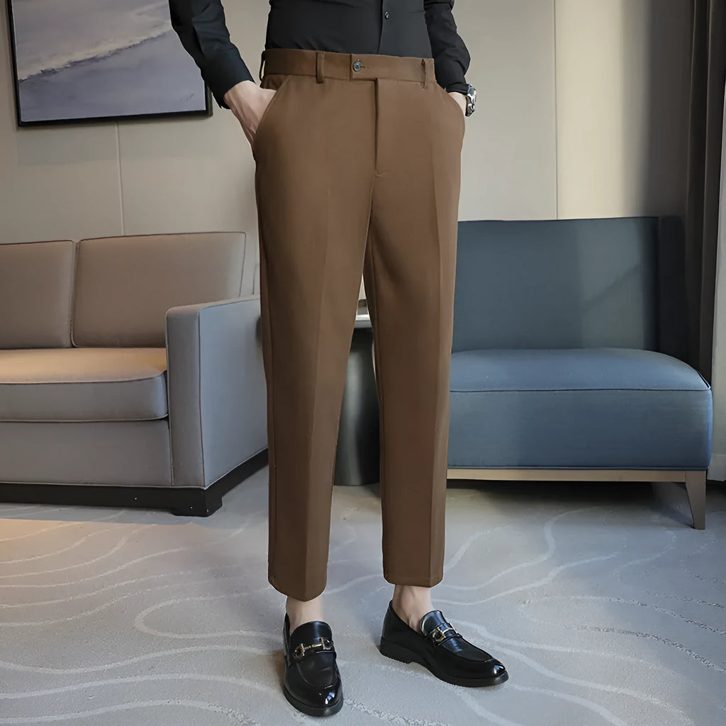 Straight-leg brown corduroy trousers with an elastic waistband laid flat.