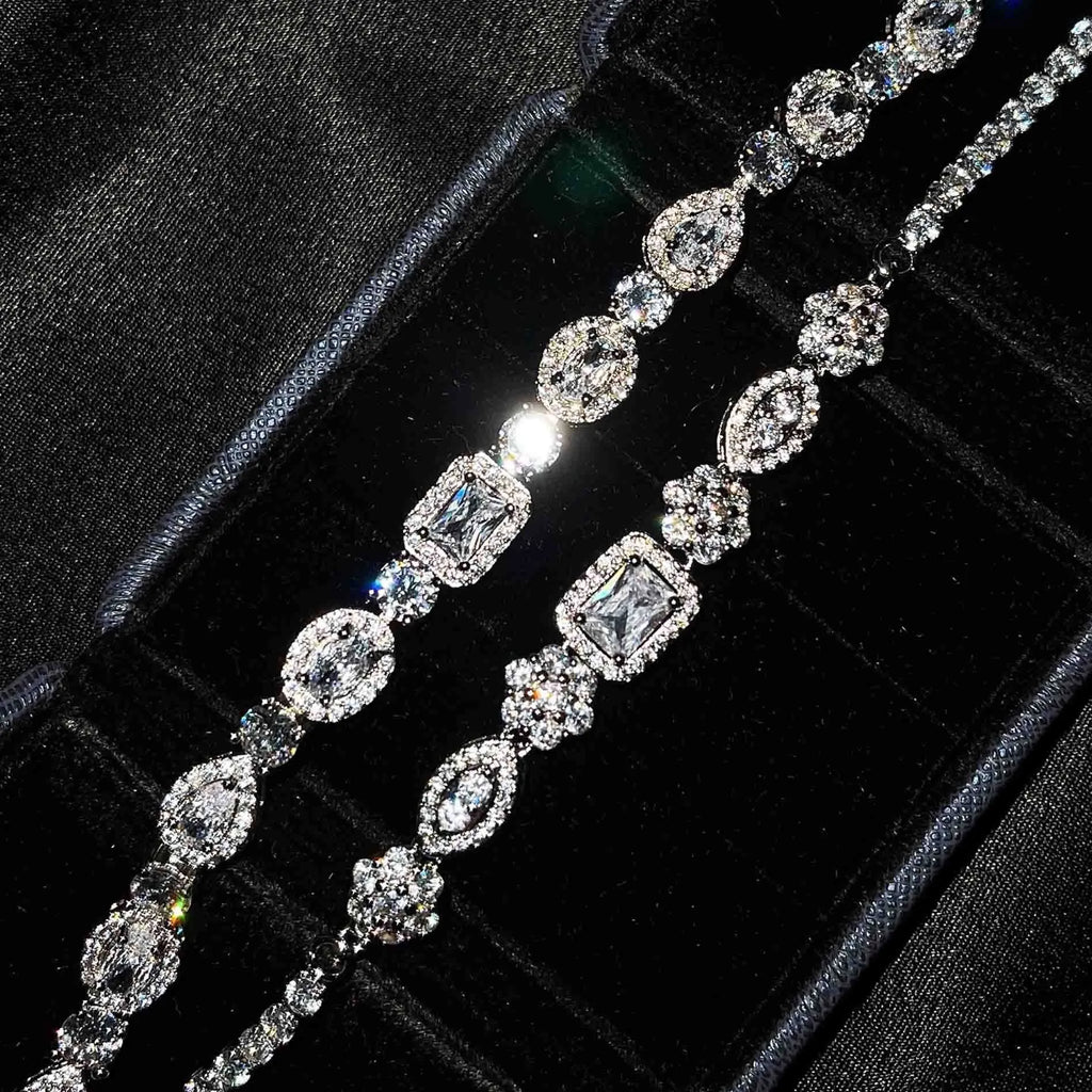Close-up of women's geometric silver bracelet with inlaid zircon stones on a wrist, showing adjustable chain links.