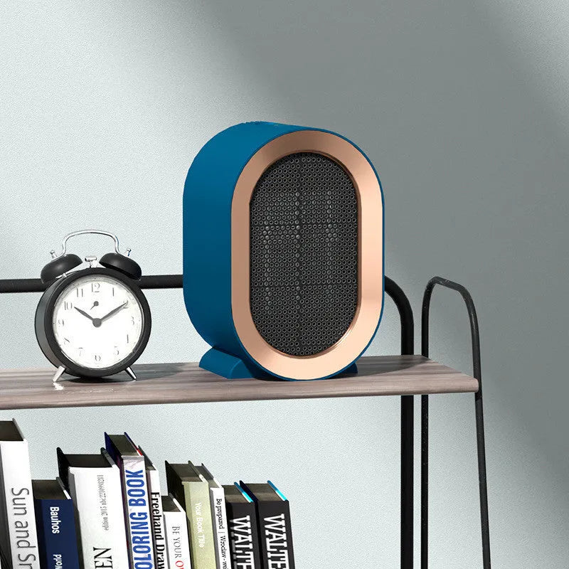 A compact black desktop ceramic fan heater with mechanical control dials.