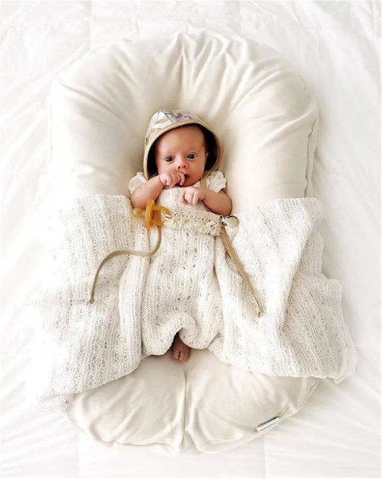 Beige portable cotton baby nest crib for infants measuring 75cm by 45cm