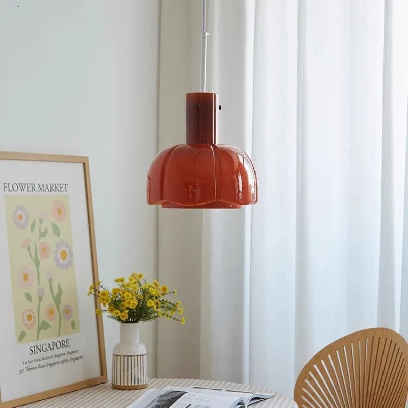 Close-up of a retro medieval-style glass bud chandelier pendant light with a warm glow.