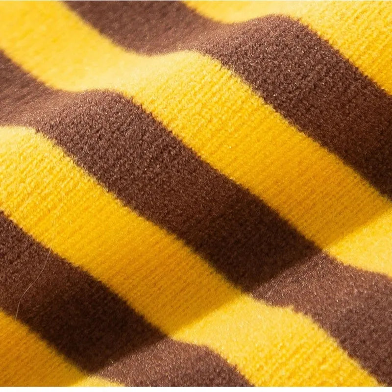 Yellow dog pajamas with bee pattern and lapel on small dog standing indoors