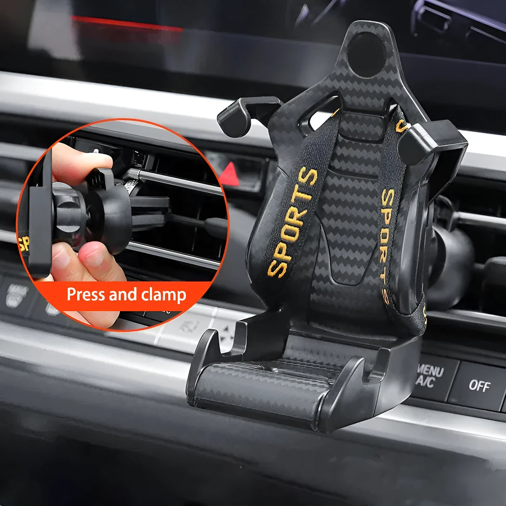 Gold car air vent phone holder with racing seat shape mounted on a car vent, showing 360-degree rotation.