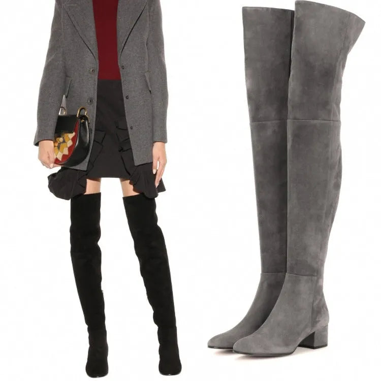 Grey suede women's over-the-knee flat boots with a pointed toe and thick low heel on a neutral background.