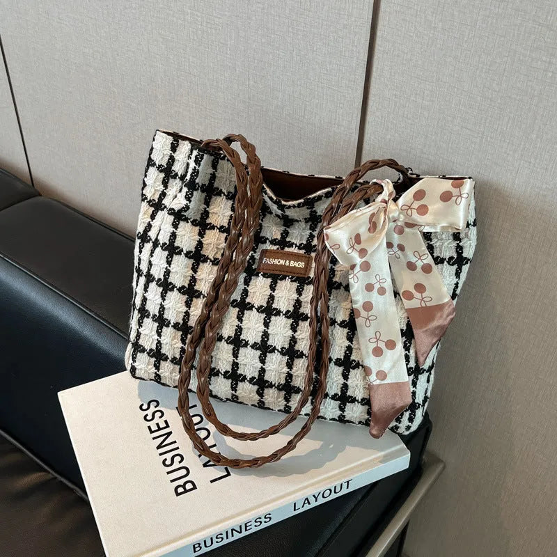 Black woolen horizontal square shoulder bag with weaving detail exterior and internal organisation compartments