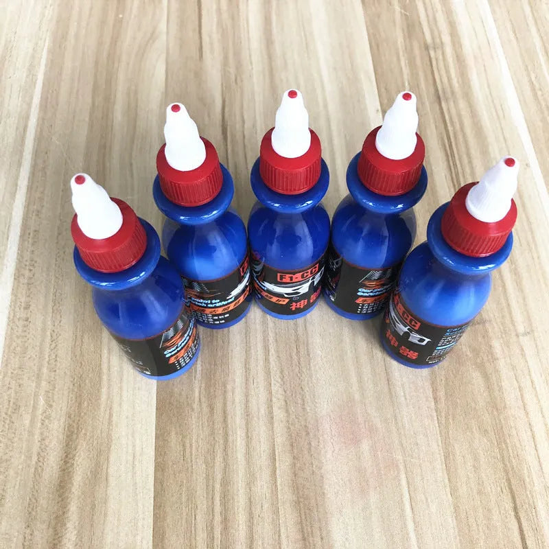 Blue automotive scratch repair agent kit with bottle and applicator for vehicle paint touch-up
