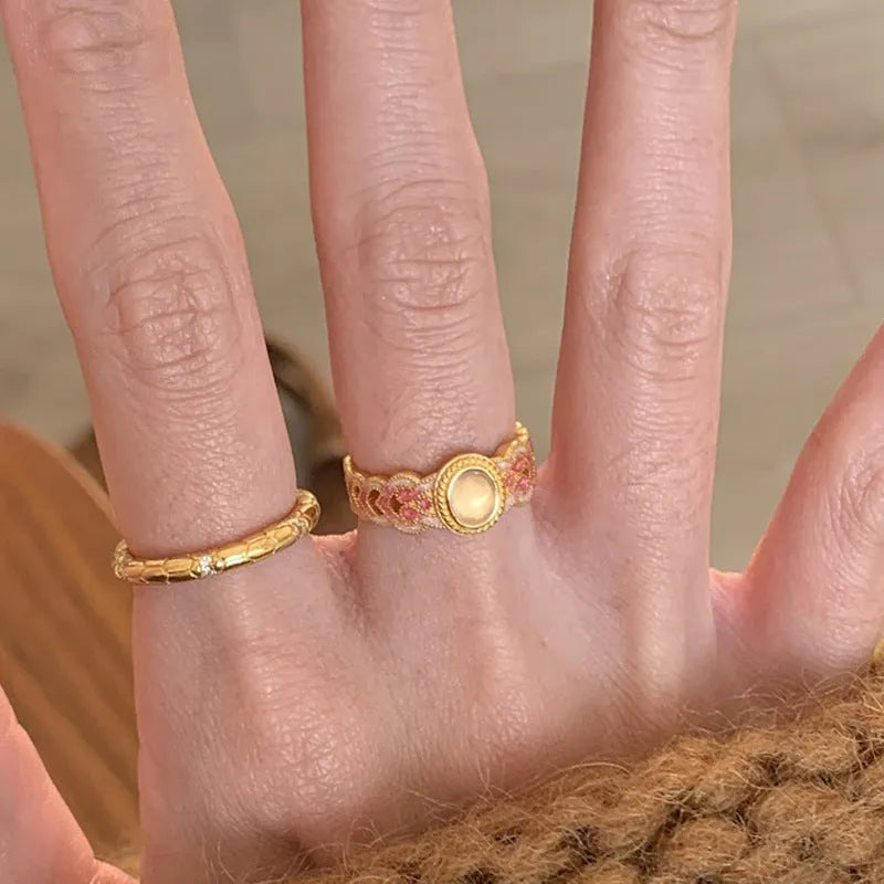 Geometric open ring with pink crystal enamel on gold-plated copper band.