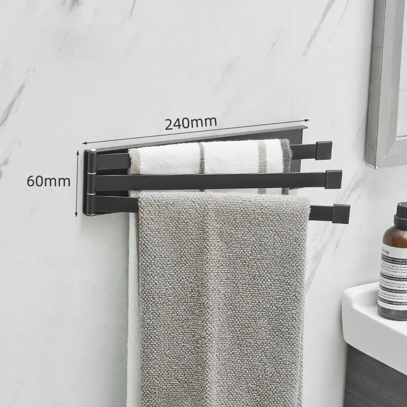 Black folding towel rack mounted on bathroom wall with adhesive installation