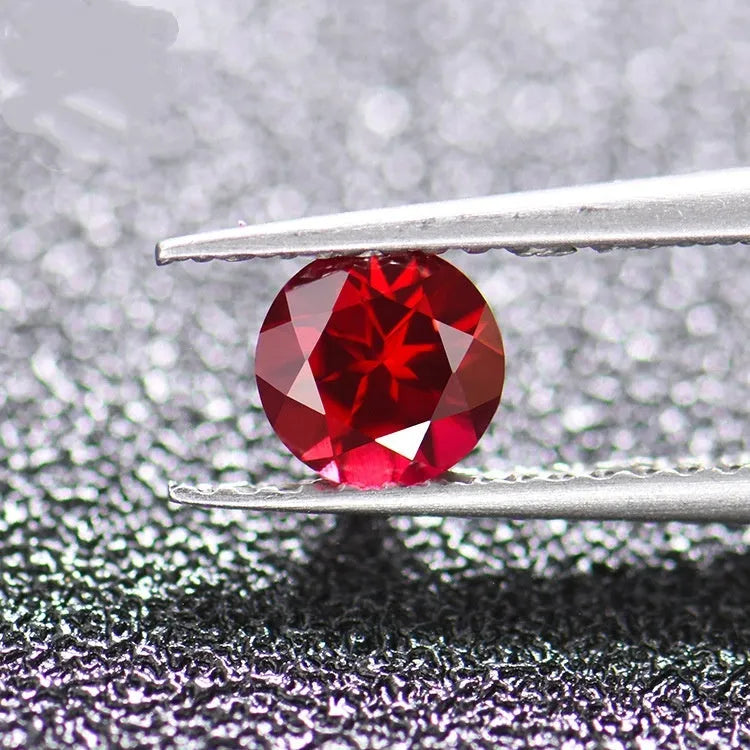 A loose, faceted artificial ruby gemstone in a deep pigeon blood red colour.