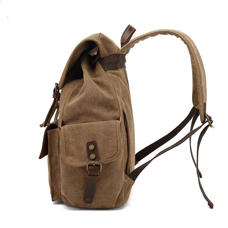 Retro canvas backpack in military green with antique bronze hardware showing front compartment organisation