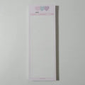 Half-B5 size vertical notepad with coloured cover, shown open to show lined pages.