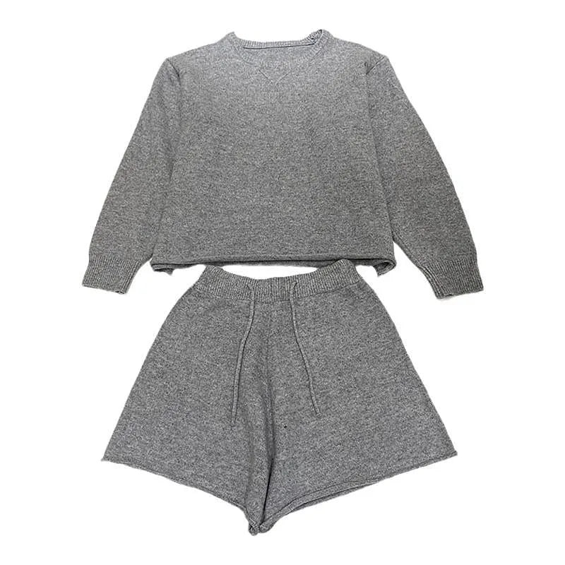 Women's loose grey acrylic knit sweater and wide-leg shorts set laid flat.